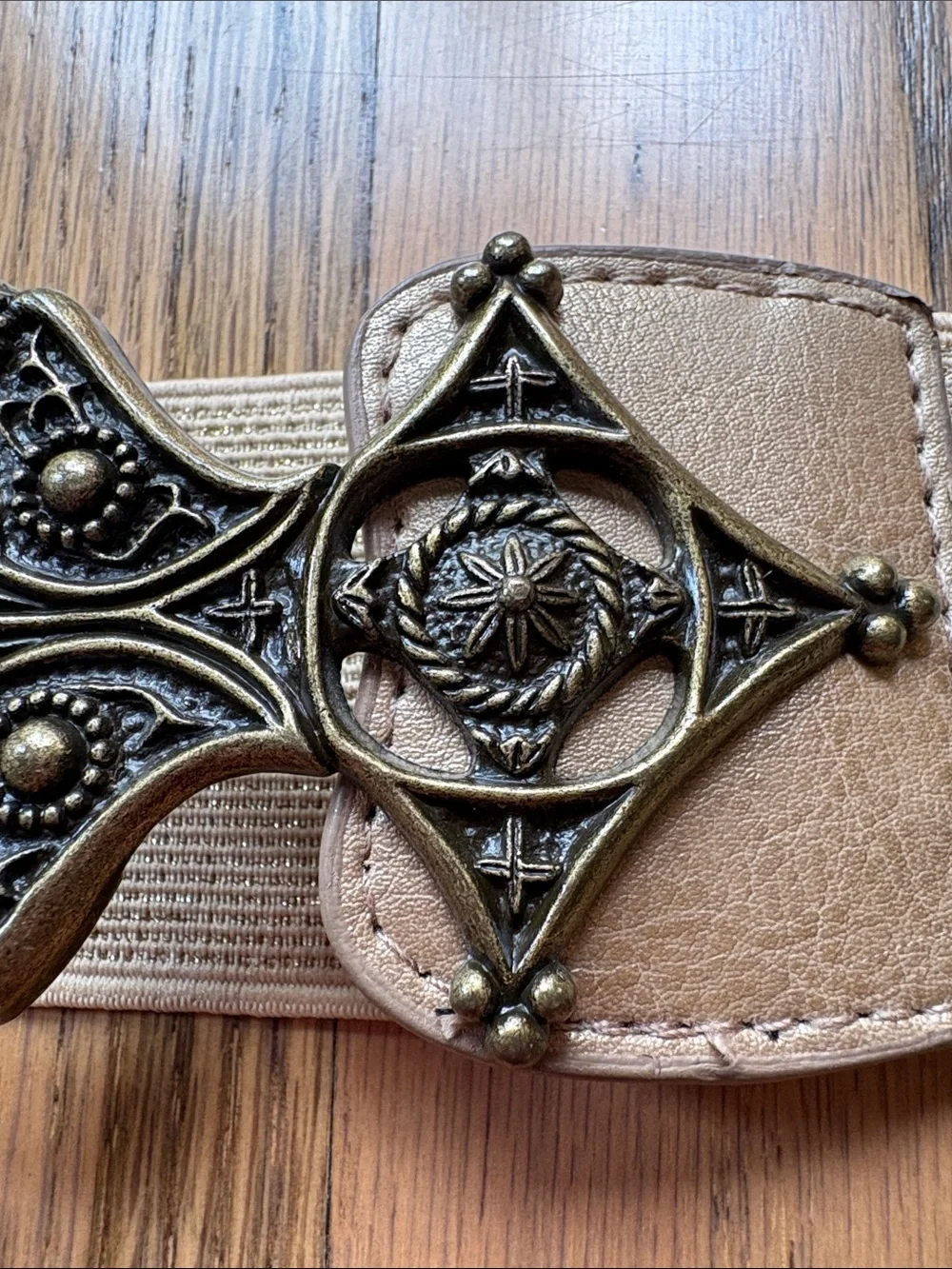 Metallic gold stretchy belt with ornate brass look buckle
